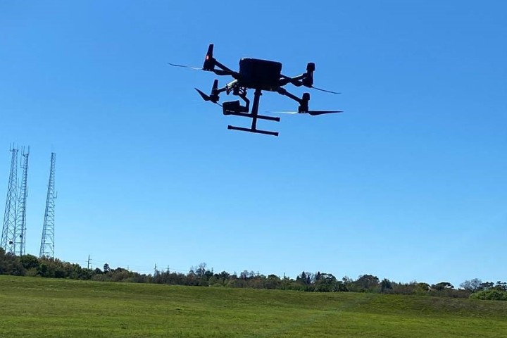 Drone hovering above grass